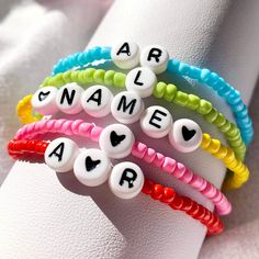 Add some beautiful colors and styles in your personalised bracelet collection.  To suffice your casual style, this gorgeous and multi-color bracelet is a must-have in your wardrobe. Our beaded bracelets are crafted from hand-picked beads, and these bracelets are a significant addition to your customized bracelet collection. Our bracelets are perfectly adjustable and can fit to any wrist size comfortably.  These colorful beaded bracelets are an ideal pick for your friends, loved ones and family m Name Bead Bracelet, Letter Bead Bracelet, Letter Bead Bracelets, Pony Bead Bracelets, Bracelet Name, Lucky Bracelet, Bracelet Friendship, Rainbow Beads, Gemstone Beaded Bracelets