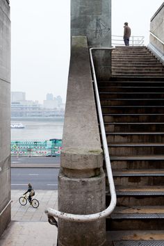 a man riding a bike down some stairs