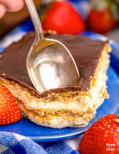 a piece of cake with chocolate frosting and strawberries