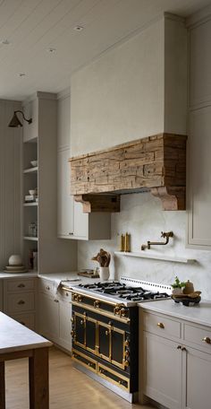 a kitchen with white cabinets and an old fashioned stove