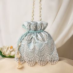 "Fancy Pearl Bead Embroidery Satin Wedding Purse Bag for Woman | Bridal Sky-Blue Purse Handbag | Fashionable Drawstring Pouch Purse Potli Bag Package Contents: 1 Size: 10\" x 8\" Designed with the heart, this beautiful Potli or batawa bag are eye catchy and made of premium material. Key Features: Embroidery art work. (zardosi work). This potli is good match with both Indian and western outfits and are superb for wedding and festive parties. This would be best complement to your designer saree, lenhga or any other kind of dress. This is the combination of traditional and modern embroidery work. This is enough to keep your accessories and all needed essentials and it can be a best gift for any woman." Festive Beaded Shoulder Bag For Wedding, Evening Potli Bag With Pearl Handle, Festive Bag With Pearl Embroidery For Reception, Elegant Bags With Pearl Embroidery For Festive Occasion, Elegant Pearl Embroidery Shoulder Bag For Festive Occasions, Elegant Pearl Embroidered Shoulder Bag For Festive Occasions, Formal Festive Bag With Pearl Embroidery, Elegant Potli Bag With Pearl Embroidery For Reception, Formal Festive Bags With Pearl Embroidery