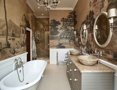 a bathroom with two sinks and a bathtub in front of a painting on the wall