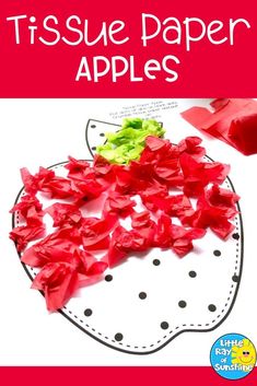 tissue paper apples on top of a white plate with red and green flowers in the middle