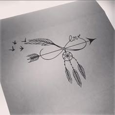 an arrow with the word love written on it and two birds flying around in the sky