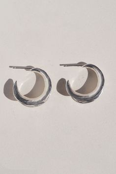 Carved minimal light weight hoop stud earrings. A unique take on a classic style. sterling silver CARE: Most metals will naturally patina over time, however, there are measures you can take to prolong the life of your jewelry. We recommend removing all jewelry prior to showering, swimming, cleaning, or applying lotions or oils. If your jewelry begins to appear a dull or darkened, it can be gently polished with a soft jewelry cloth like Sunshine, with a non-abrasive jewelry cleaner, or a natural Silver Minimalist Hoop Plug Earrings, Minimalist Silver Hoop Plug Earrings, Everyday Silver Small Hoop Wrap Earrings, Everyday Small Hoop Silver Wrap Earrings, Everyday Small Hoop Wrap Earrings In Silver, Unique Small Hoop Earrings For Everyday, Hand Forged Minimalist Earrings For Anniversary, Minimalist Hand Forged Earrings For Anniversary, Anniversary Hand Forged Minimalist Earrings