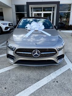 a mercedes car with a bow on the hood