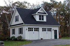 a white garage with black roof and windows