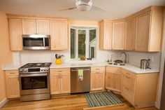 a kitchen with wooden cabinets and stainless steel appliances