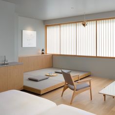 an empty room with wooden furniture and large windows