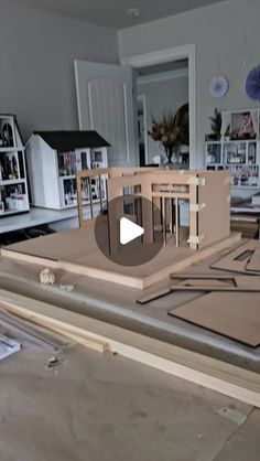 a video demonstrating how to build a dollhouse from plywood and wood planks