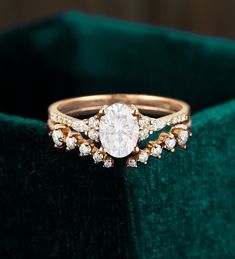 a diamond ring sitting on top of a velvet bag