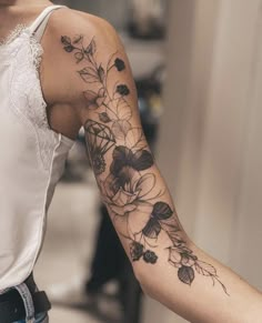 a woman with a flower tattoo on her arm