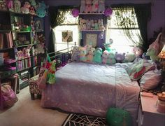 a bedroom with purple walls and lots of stuffed animals