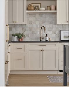 the kitchen is clean and ready for us to use it's counters are white with gold trim