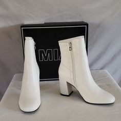 White Bootie Cut From Sleek Faux Leather Is Lofted By A Wrapped Block Heel Elegant White Boots With Zipper Closure, Elegant White Boots With Zipper, White Synthetic Boots For Formal Occasions, Trendy White Boots For A Night Out, White Boots For Night Out In Fall, Chic White Boots For Night Out, Mia Shoes, White Boots, Bootie