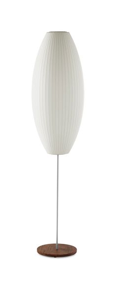 a white table lamp on a wooden base