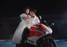 a man and woman are riding on a motorcycle