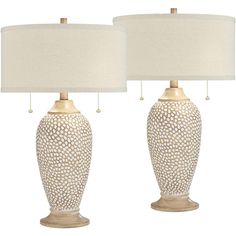 two white ceramic lamps with beige shades