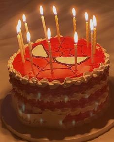 a spiderman birthday cake with candles on it