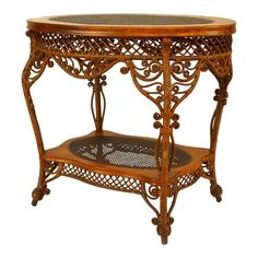 an ornately carved wooden table with wicker on the top and shelf below it