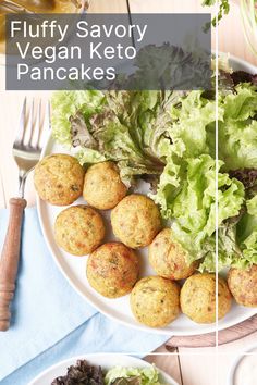 a white plate topped with meatballs and lettuce next to a bowl of salad