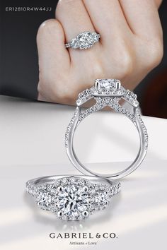 a woman's hand holding an engagement ring with two diamonds on the top and bottom