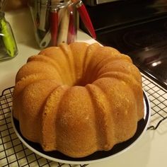 a bundt cake sitting on top of a black and white plate next to a stove