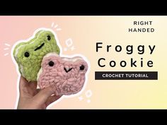 two crocheted cookies with the words froggy cookie in front of them, on a pink and yellow background