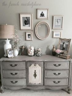 an old dresser is decorated with pictures and flowers