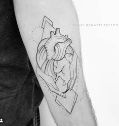 a black and white photo of a heart tattoo on the left arm with geometric shapes