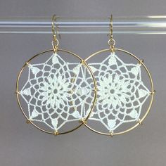 "Crochet doily earrings in white silk. Adapted from vintage motif \"No. 3\" from the 1940s. The diameter is approximately 1-5/8\", surrounded by 14K gold-filled hoops. They are lightweight and very comfortable. The jewelry has been treated with a water- and stain-repellent finish. Please be careful with your cosmetics and moisturizers, and you will have this lovely, lacy jewelry for years to come. Please remember, your screen may display colors differently from the actual item." White Bohemian Filigree Earrings, Delicate White Hoop Earrings With Ear Wire, Delicate Handmade White Hoop Earrings, Bohemian White Pierced Hoop Earrings, White Bohemian Pierced Hoop Earrings, White Round Filigree Earrings, Adjustable White Hoop Earrings For Wedding, Bohemian White Crochet Earrings, Vintage White Filigree Earrings