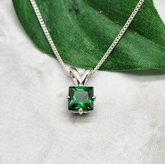 Deep emerald green cz stone has been handset into a sterling silver setting.  The solitaire is the star of the show and is lovely on its own or as a layering necklace.  The square shape is a bit more unusual and add to the beauty of the blue sapphire pendant. Emerald is the May birthstone. The princess cut stone is6x6mm.  Emerald green cubic zirconia stone.  Both the setting and the curb chain are 925 sterling silver. Items are shown larger in pictures to show detail - please note the dimensions. Jewelry is packaged in a cotton lined box for gift-giving. See more Bonny Jewelry at http://bonnyjewelry.etsy.com Deep Emerald Green, Blue Sapphire Pendant, Silver Items, May Birthstone, Sapphire Pendant, Solitaire Pendant, Layering Necklace, Curb Chain, Cz Stone