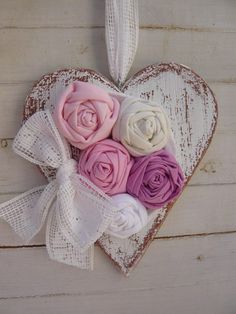 a heart shaped box filled with pink and white flowers