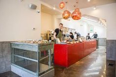 a man standing in front of a counter filled with food