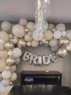 the bride balloon arch is decorated with white and silver balloons