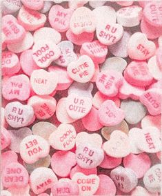 candy hearts with the words i love you written on them in pink and white colors