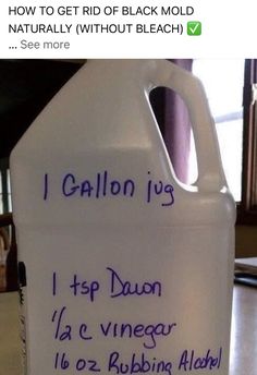 a plastic jug with writing on it sitting on a table