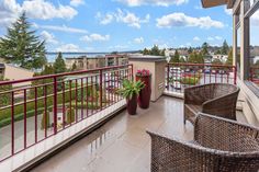 a balcony with wicker chairs and potted plants