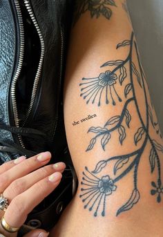 a woman's arm with tattoos on it and the words she southern written in cursive font