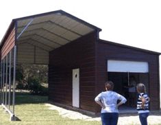 two women are standing in front of a garage