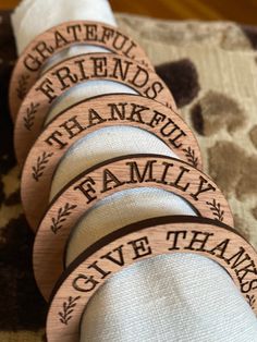 four wooden coasters with the words grateful friends thank family give thanks written on them