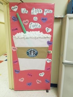 a door decorated like a starbucks cup with the words we love you, latte on it