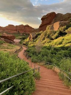 there is a wooden path going up to the top of this hill in the desert