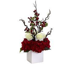 a white vase filled with red and white flowers