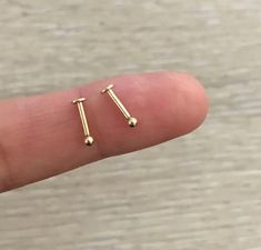 a person's finger with two small screws on it