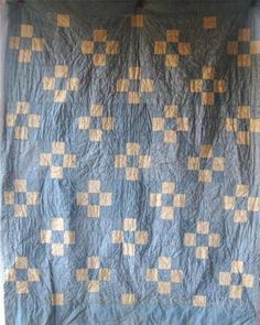 a blue and yellow quilt with squares on it