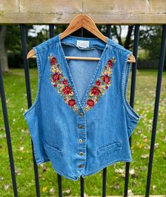 Wonderful women's TABI denim vest with embroidered flowers on the front.  No size tag so please refer to the measurements below to ensure proper fit.  Estimated size is L.  Main button closure.  Very good overall condition with no notable flaws.  Chest: approx. 21.5 inches from armpit to armpit.  Length: approx. 21 inches from neck down to hem (taken in the front).  Please contact us with any questions. Thanks for stopping by! Jeans Patches, Fall Vest, Patched Jeans, Vintage Fall, Vest Outfits, Embroidered Denim, Denim Vest, Embroidered Flowers, Womens Vest