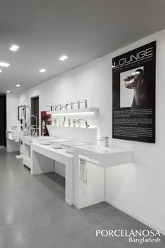 a large white bathroom with sinks and toiletries on the wall next to each other