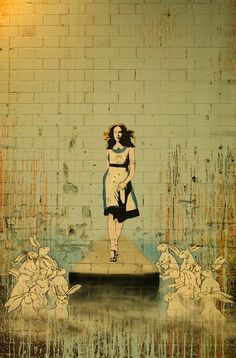 a painting on the side of a brick wall depicting a woman walking down a runway