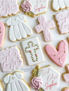 decorated cookies are arranged on a white surface